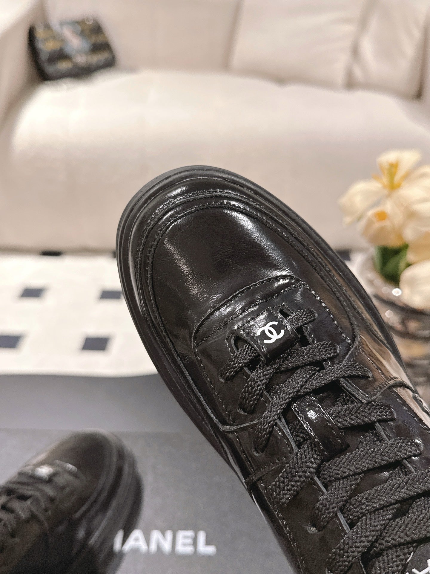 Black leather sneaker upper with Chanel CC patch and laces