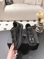 Black leather lace-up sneakers with lace eyelets and side logo