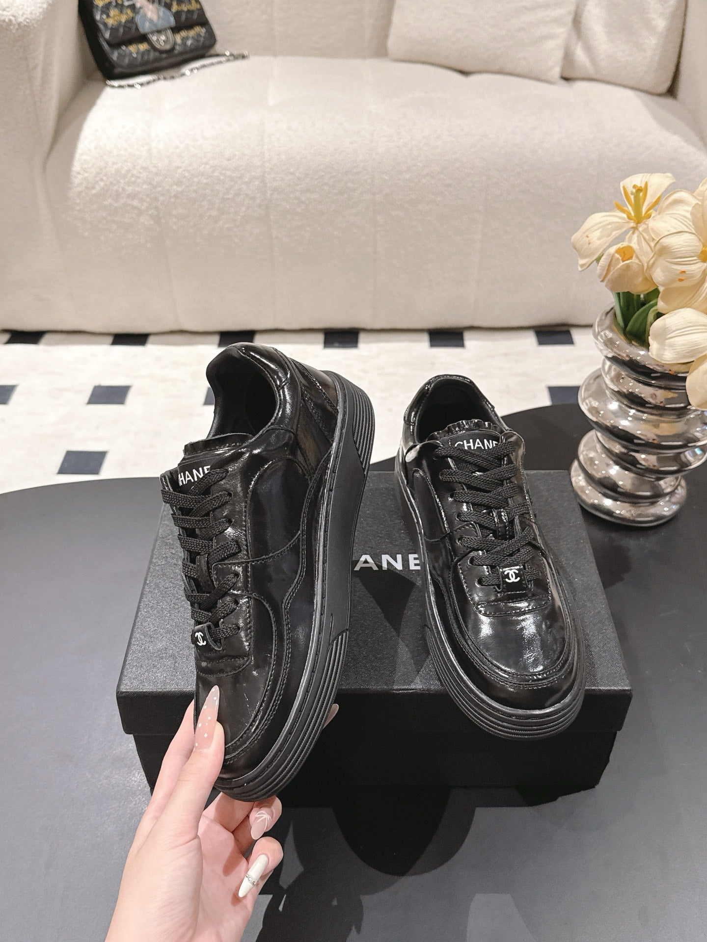 Black leather lace-up sneakers with lace eyelets and side logo