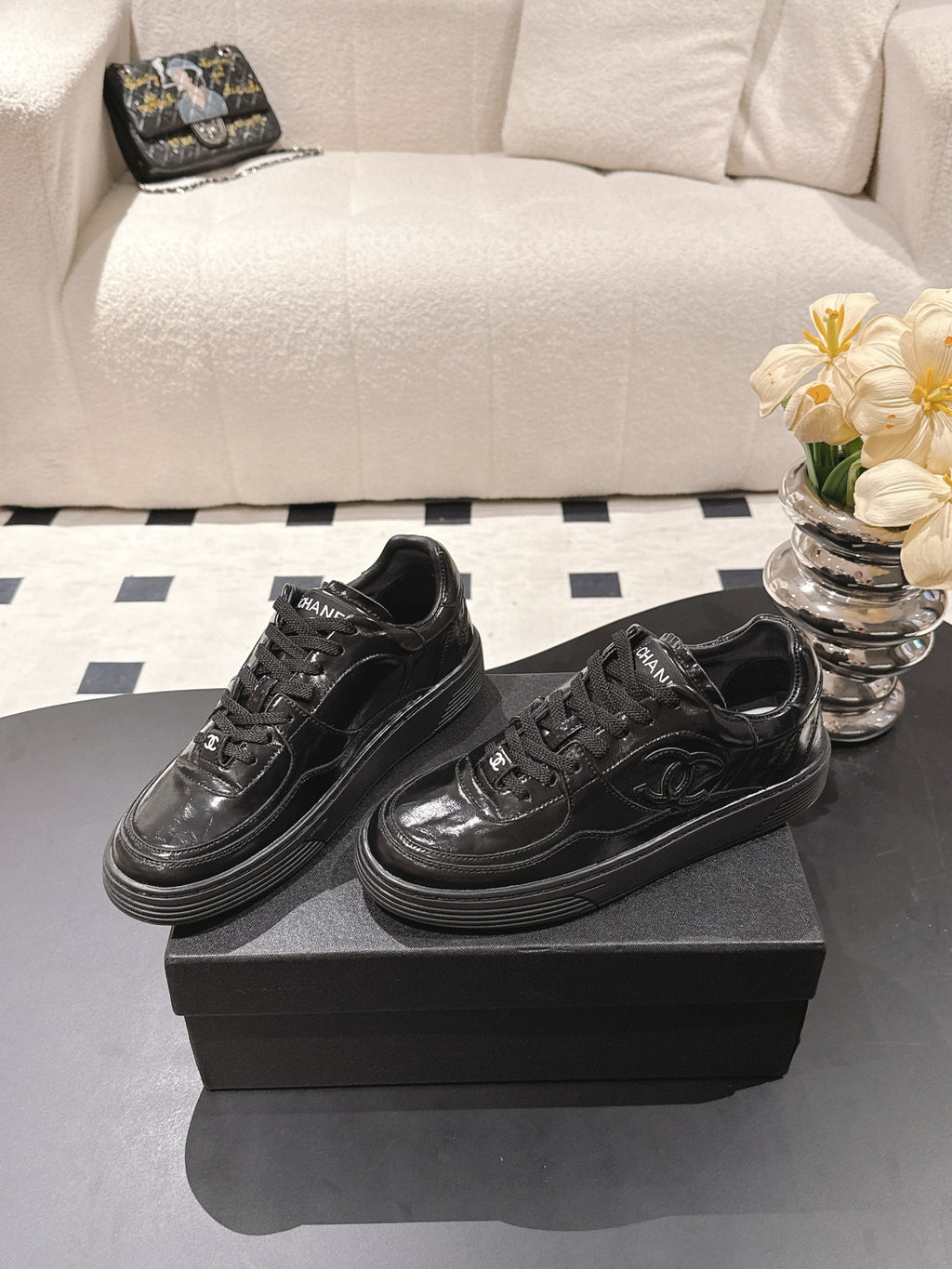 Black leather lace-up sneakers pair on box