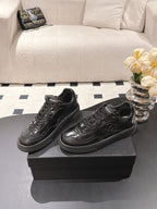 Black leather lace-up sneakers pair on box