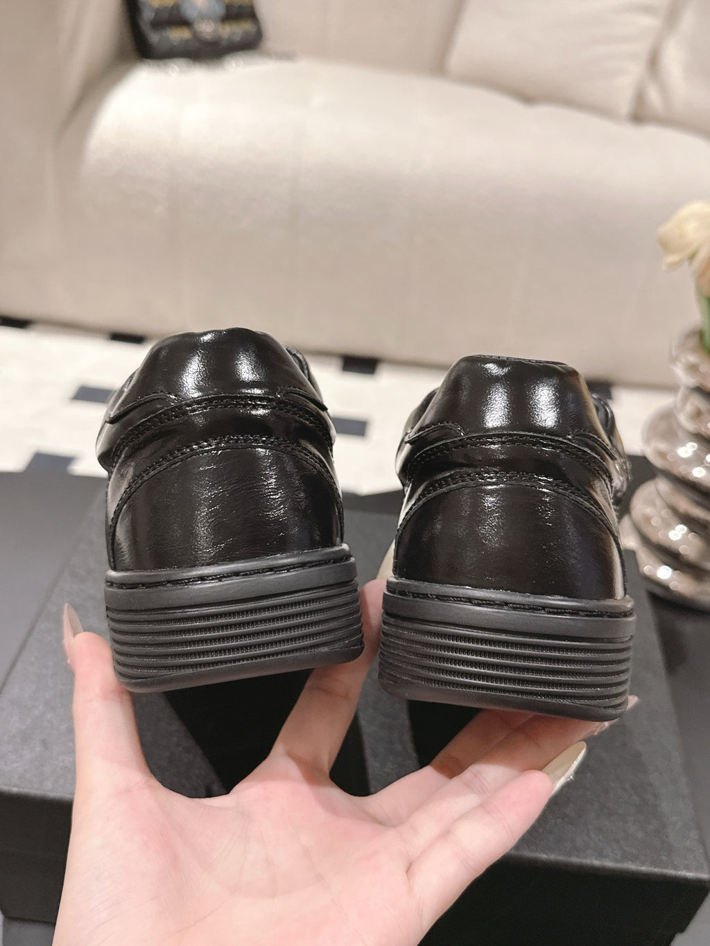 Black leather sneakers from back with ribbed sole and heel stitching