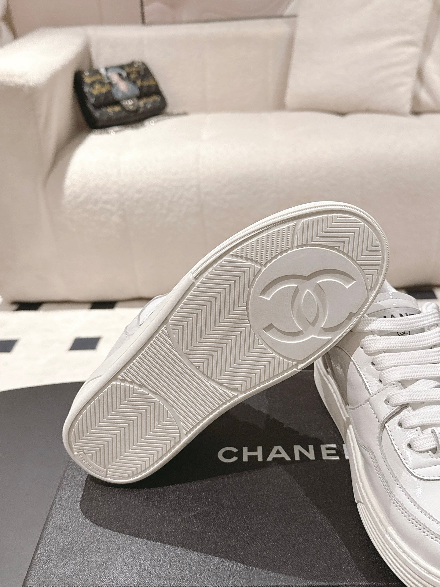 White Chanel sneaker outsole with CHANEL circular logo and textured tread
