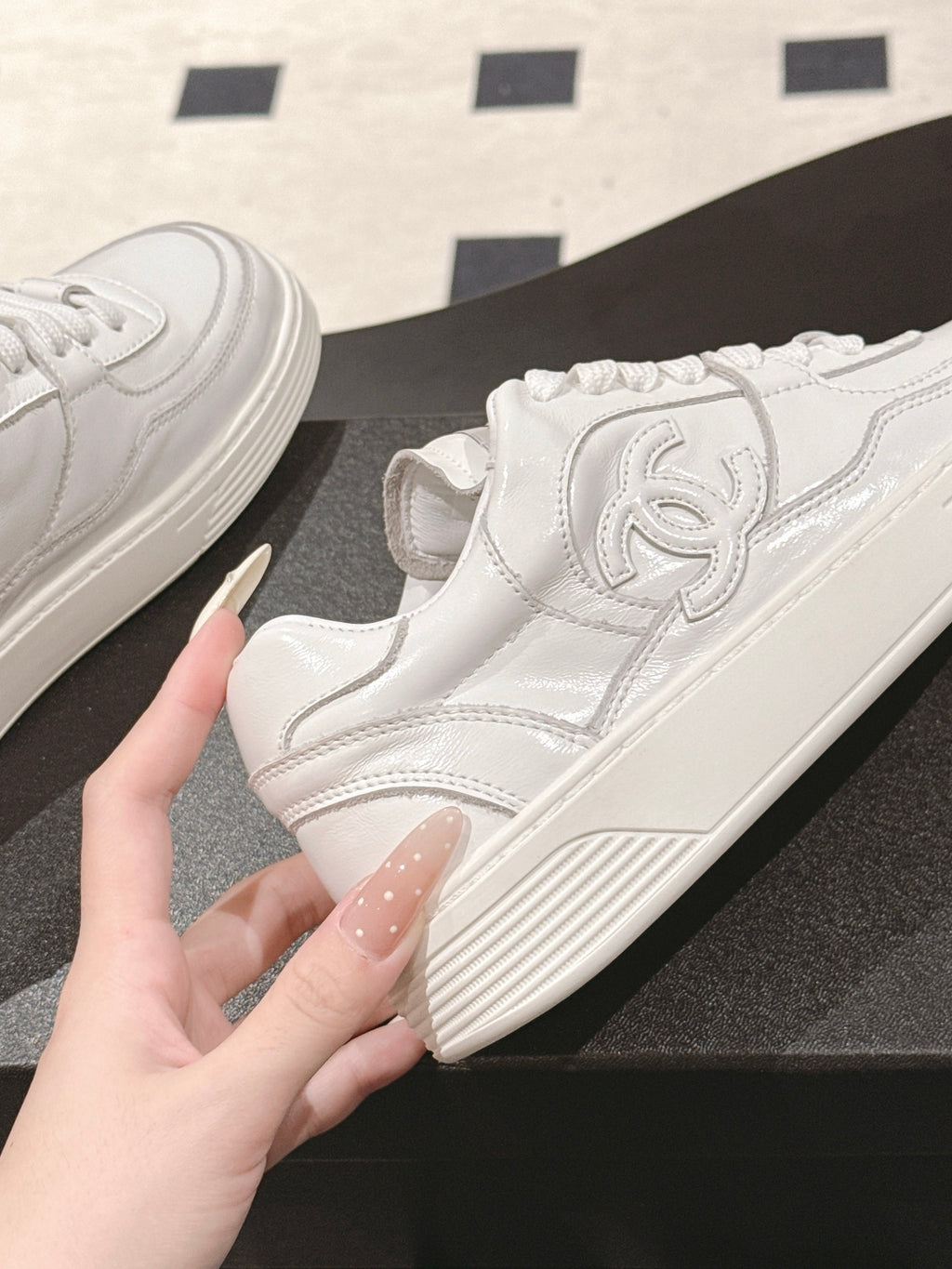 White Chanel skate sneaker with raised CC emblem on side