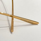 Gold metal eyeglass arm with Bottega Veneta engraved lettering