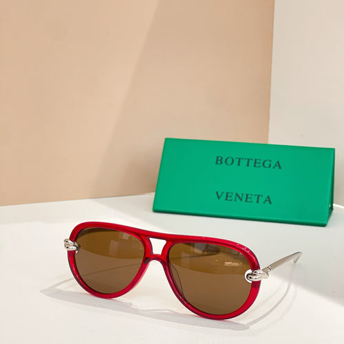 Red cat-eye sunglasses with gold temples and amber tinted lenses
