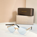 Bvlgari sunglasses with pale blue tinted lenses, black frame and gold accents.