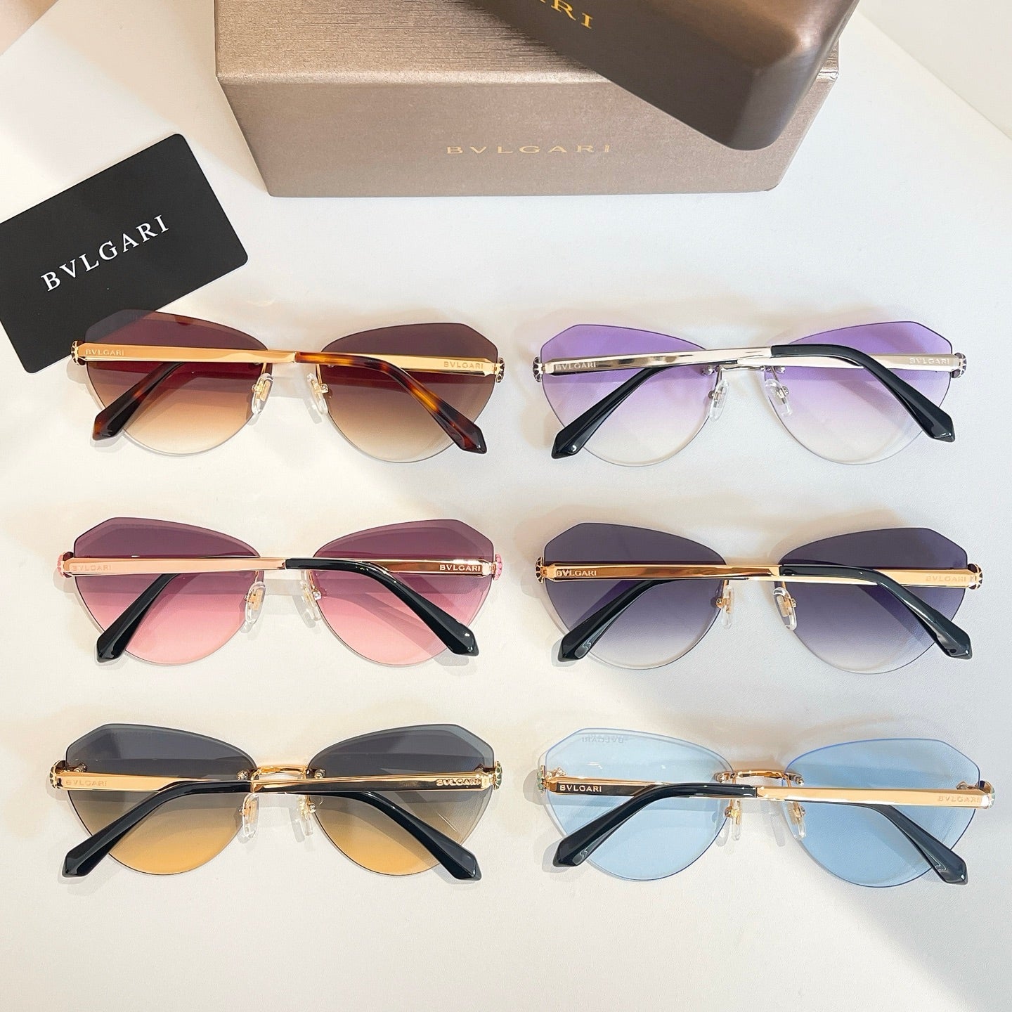 Bvlgari sunglasses set with amber, purple, pink and blue tinted lenses, gold details.