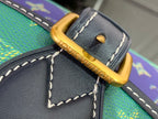 Gold-tone buckle and D-ring on monogram shoulder strap with dark leather edging
