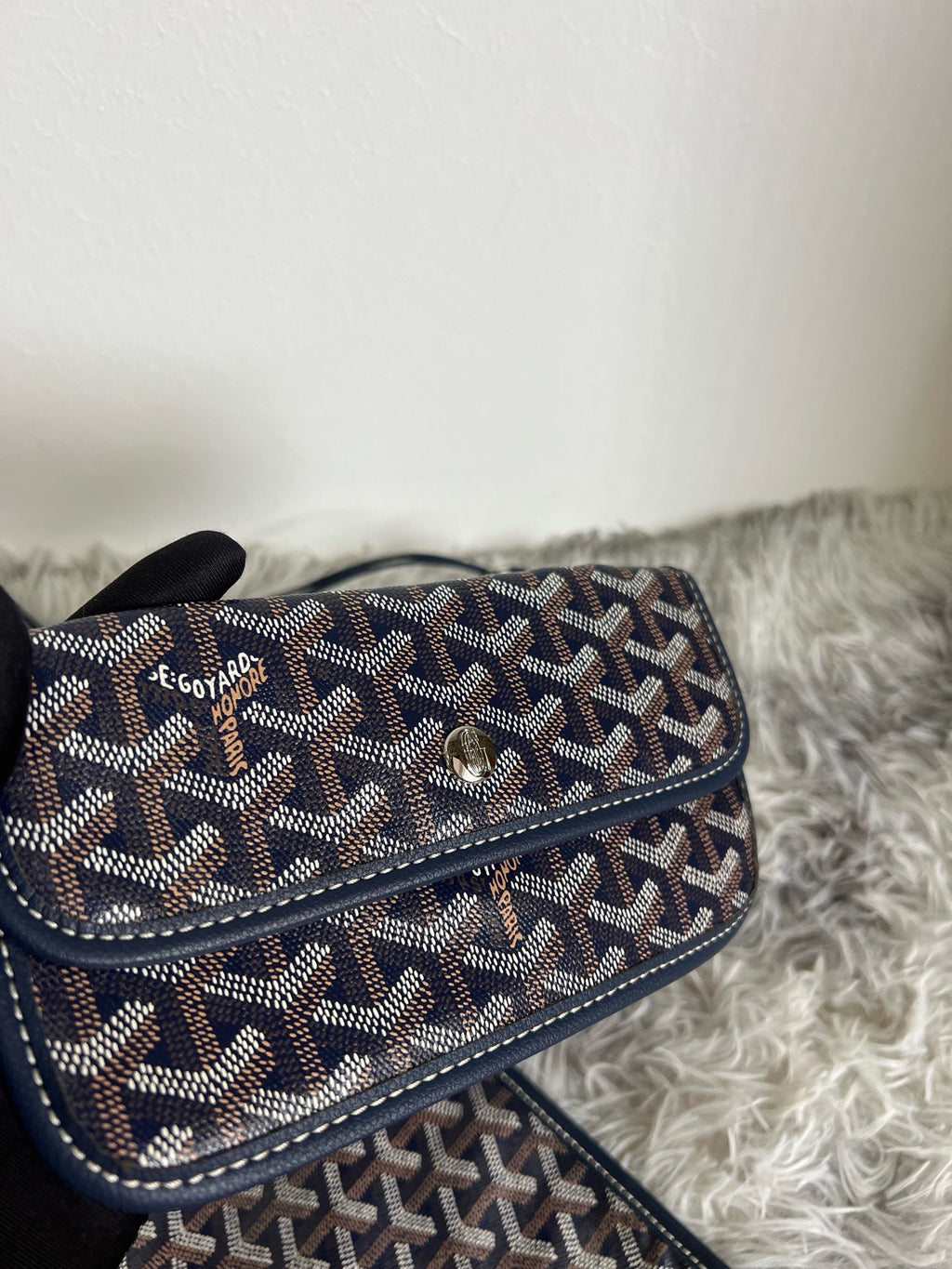 Goyard crossbody bag, dark patterned flap with turn-lock clasp and long strap