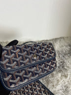 Goyard crossbody bag, dark patterned flap with turn-lock clasp and long strap