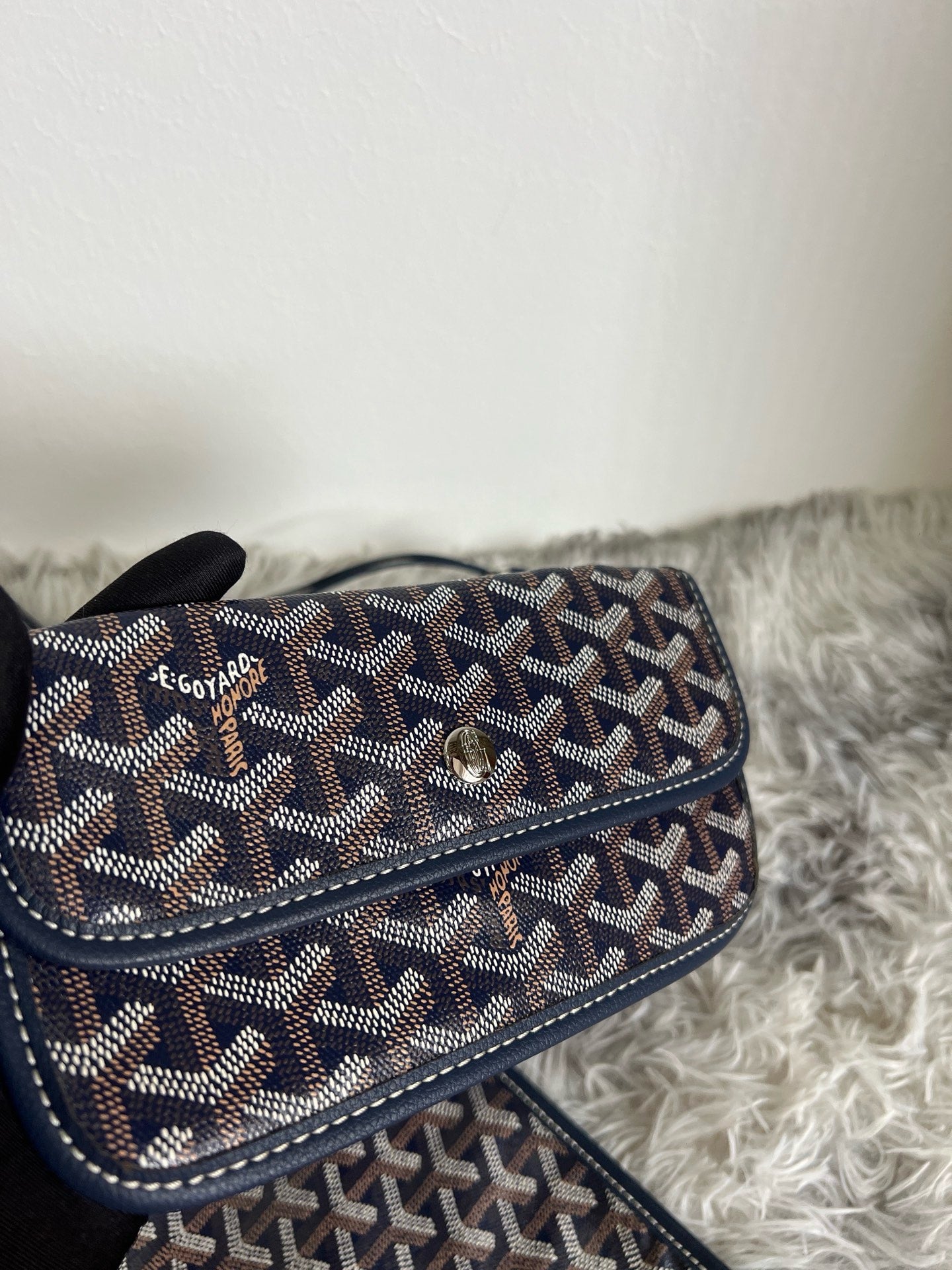 Goyard crossbody bag, dark patterned flap with turn-lock clasp and long strap