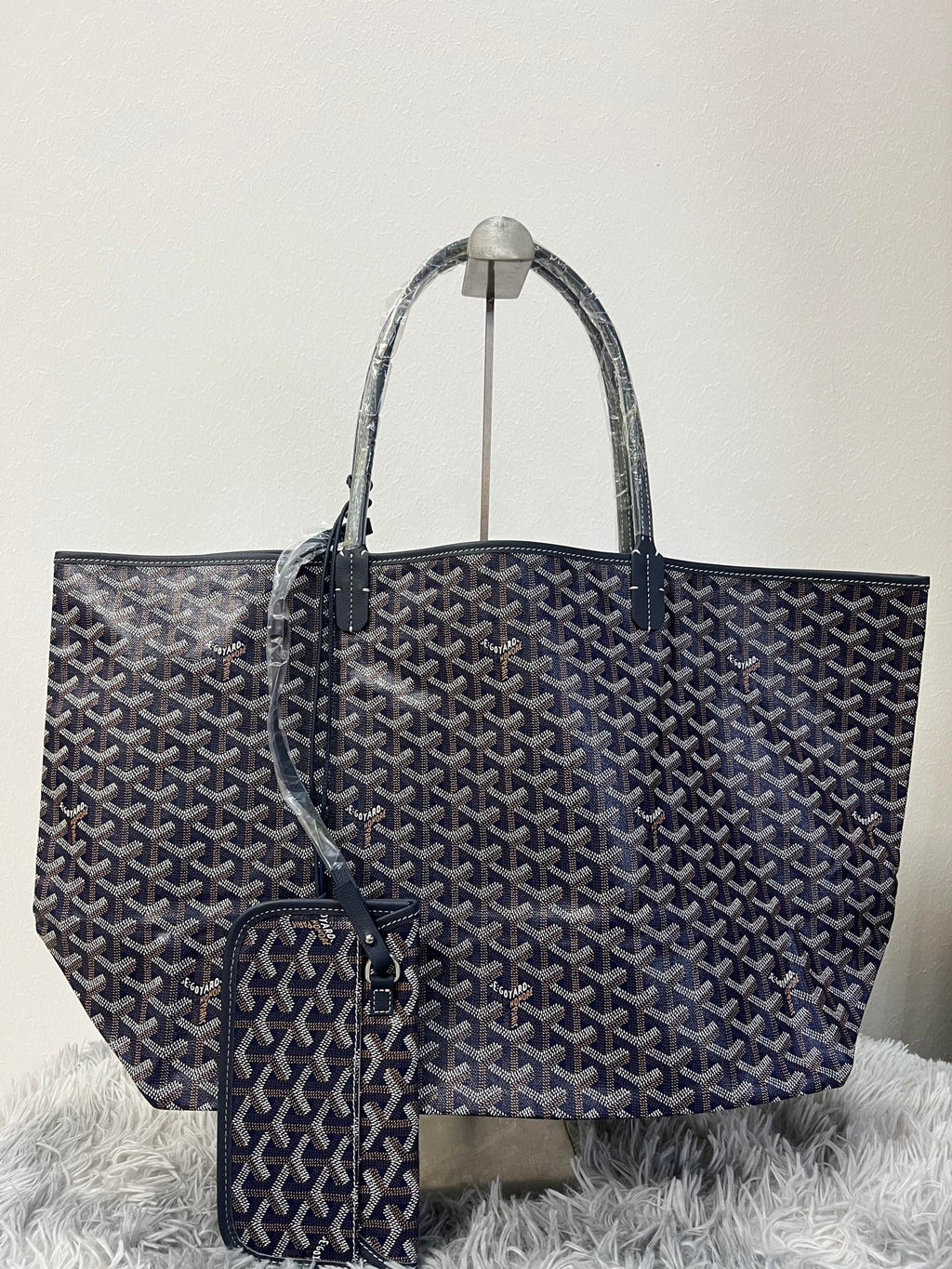 Goyard tote bag, dark patterned canvas, top handles, front clasp detail