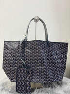 Goyard tote bag, dark patterned canvas, top handles, front clasp detail