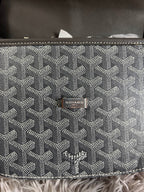 Back panel of monogram crossbody bag with Goyard logo patch