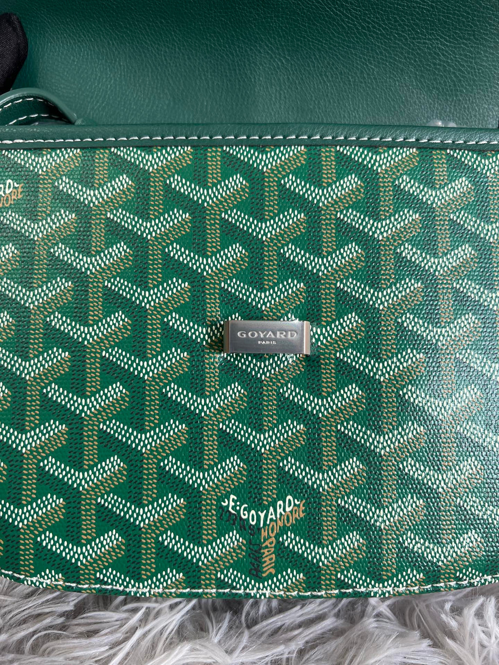 Green Goyard patterned canvas with centered logo patch and white contrast stitching