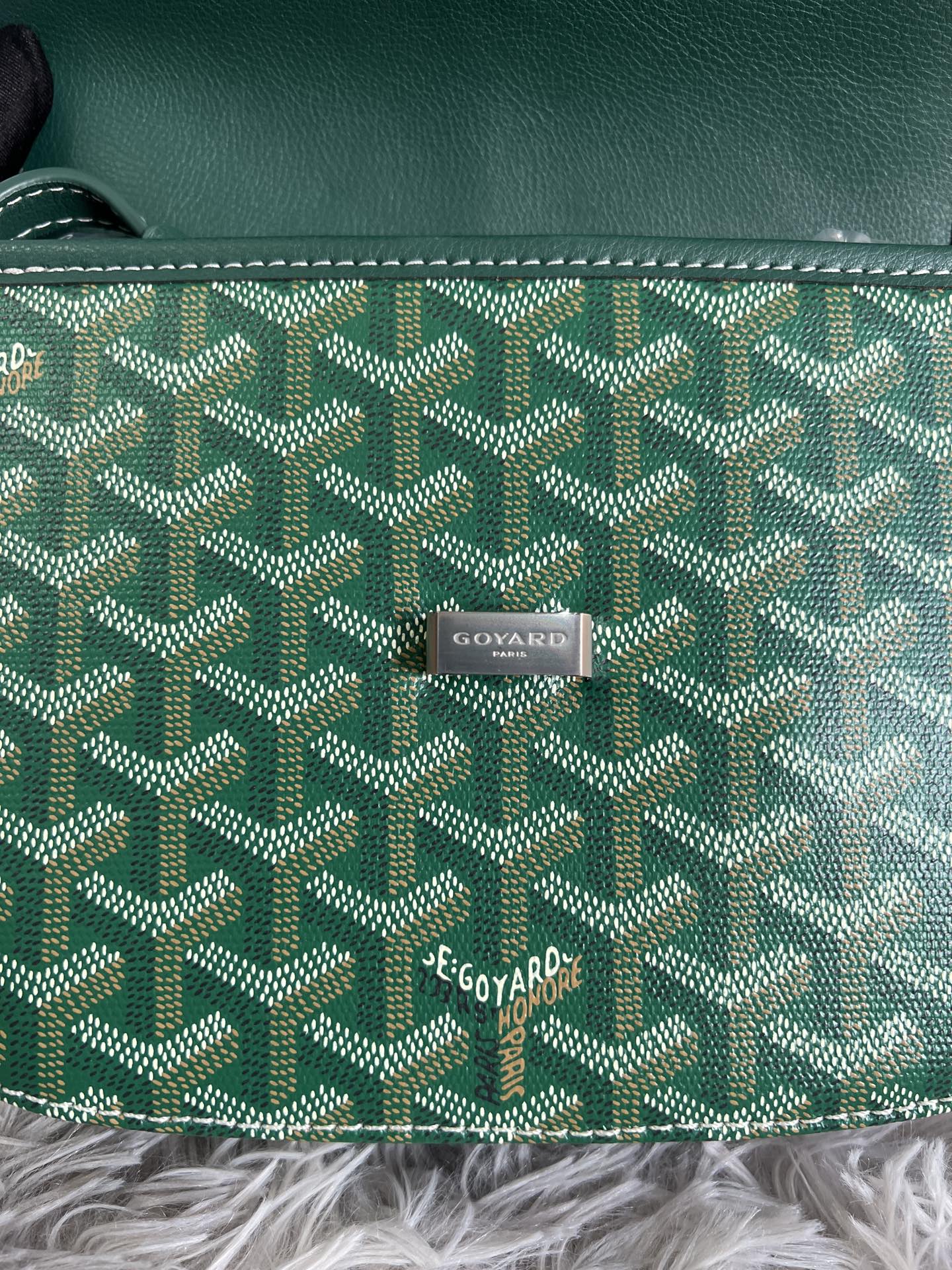 Green Goyard patterned canvas with centered logo patch and white contrast stitching