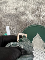 Green leather trim of bag with protective packaging and padded interior materials