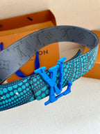 Louis Vuitton belt detail showing turquoise polka-dot strap and blue metal buckle
