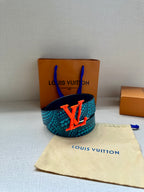 Blue-and-turquoise patterned belt with red LV buckle, strap lying flat.