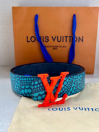Turquoise-and-blue patterned belt with bold red LV buckle, centered on the strap.
