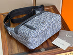 Dior crossbody bag with blue monogram pattern, structured shape, and adjustable strap