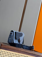 Dior men's shoulder bag with blue monogram fabric, flap closure, and wide strap