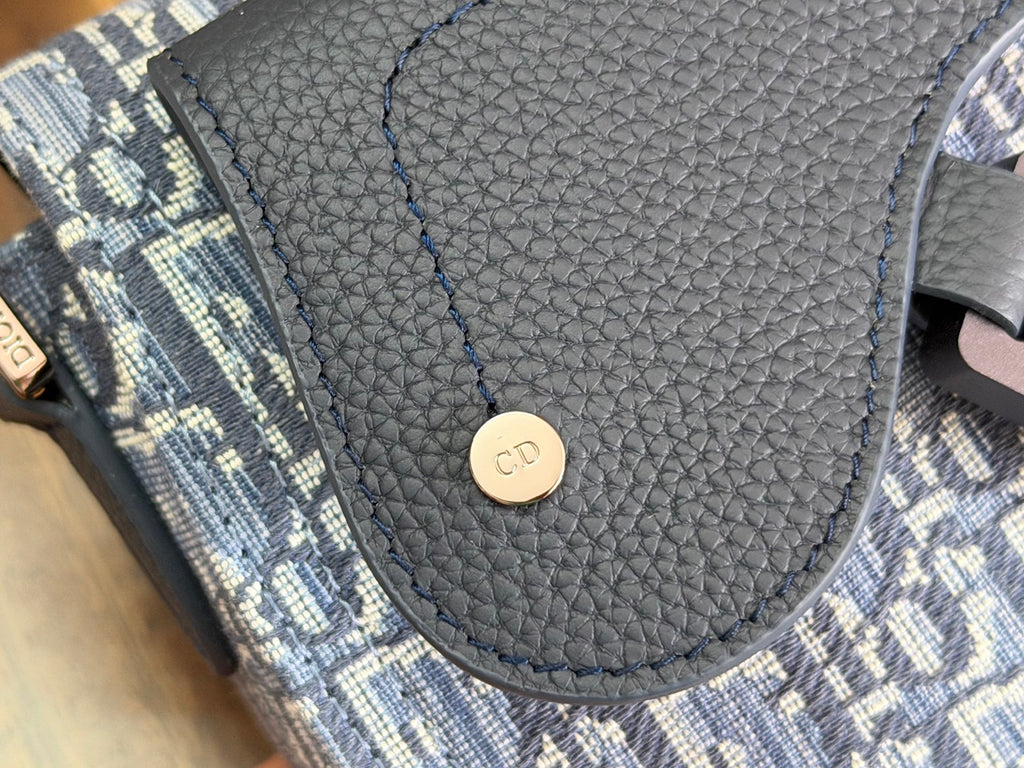 Blue monogram crossbody bag front panel with pebble-texture leather flap tab