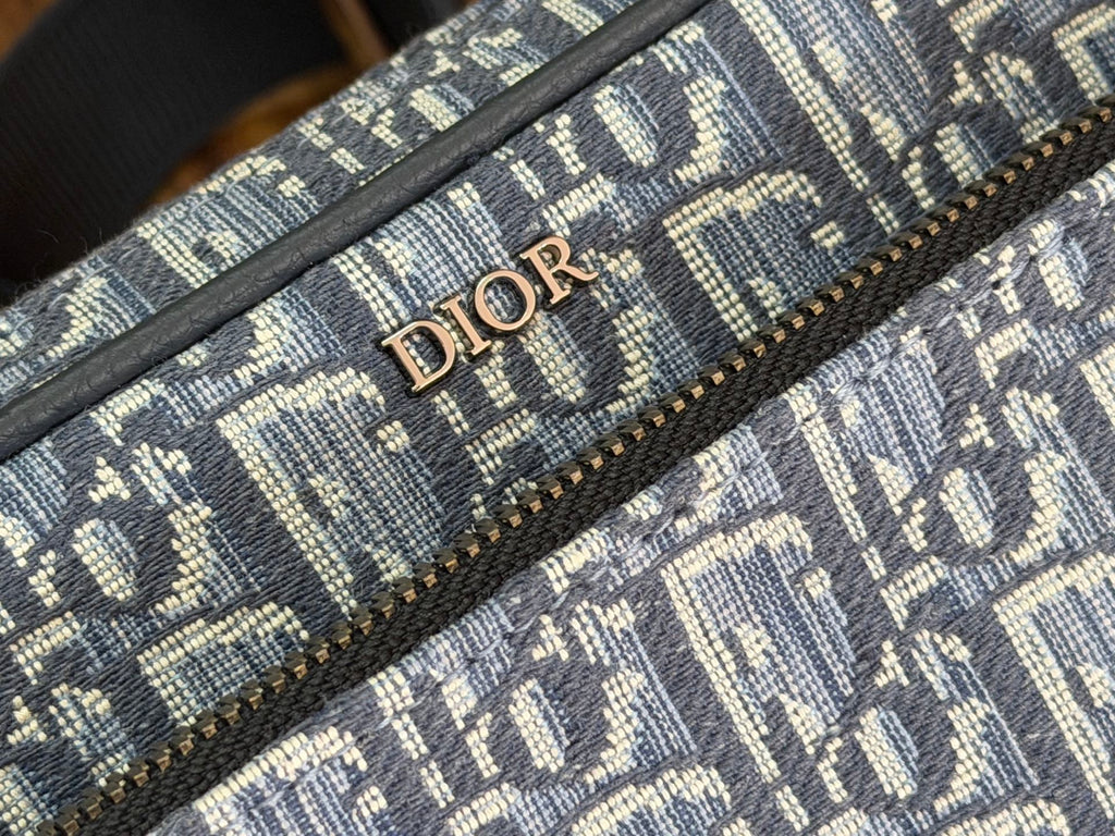 Blue Dior monogram fabric detail with 'DIOR' lettering on canvas