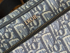 Blue Dior monogram fabric detail with 'DIOR' lettering on canvas