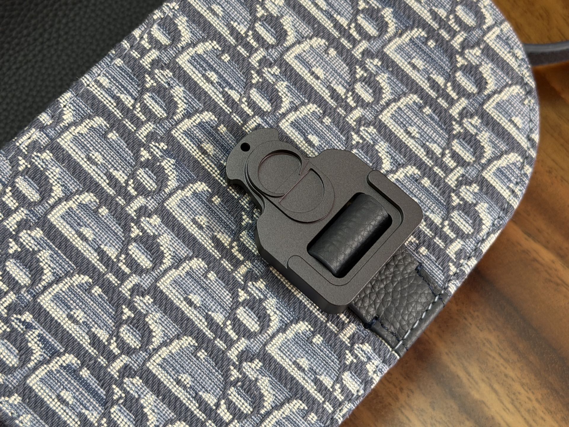 Dior crossbody bag snap strap connector on monogram-patterned canvas and leather