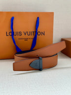 Tan leather belt with dark blue buckle plate and stitched strap edge