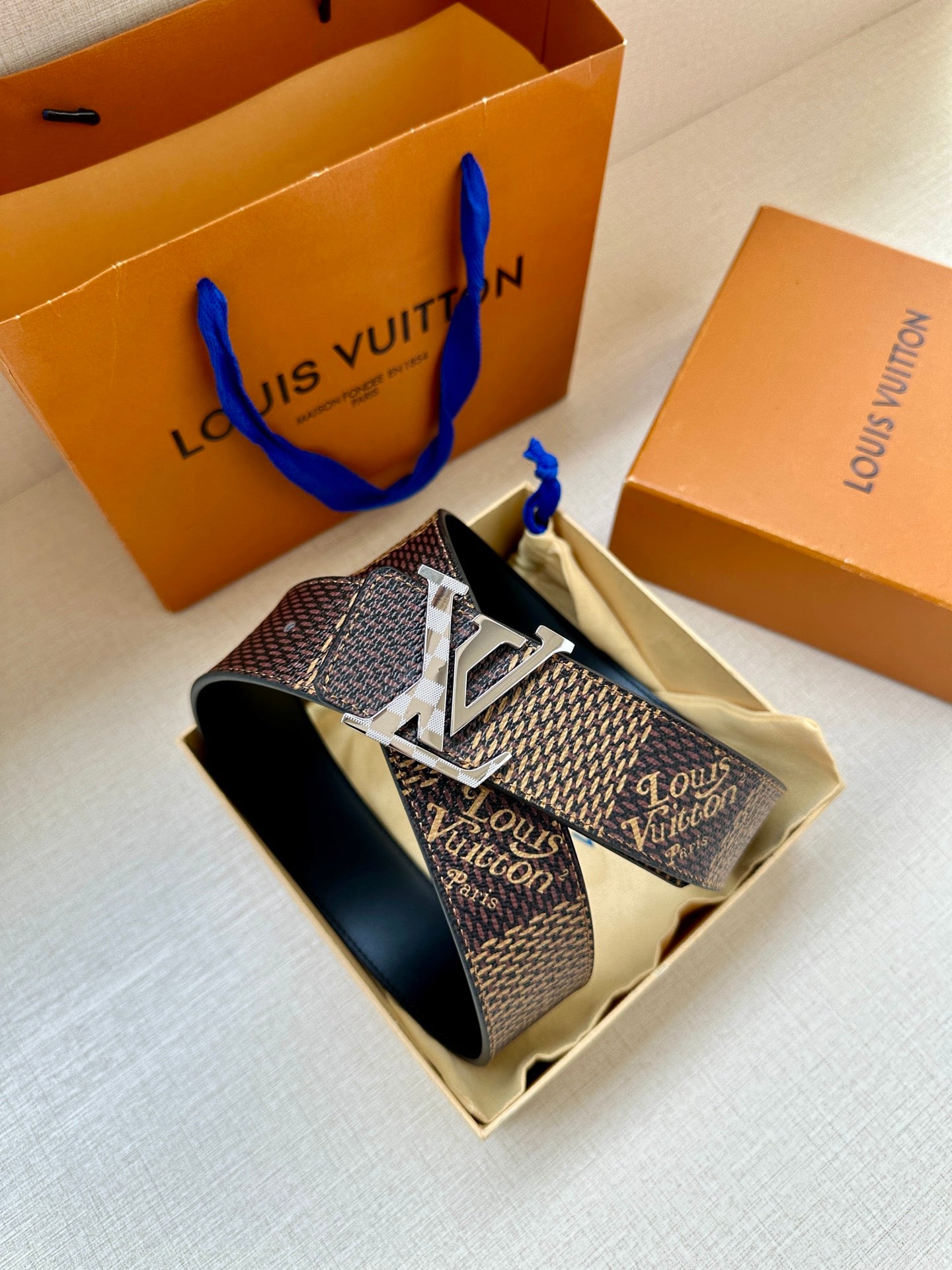 Louis Vuitton monogram belt with oversized silver LV buckle and dark strap