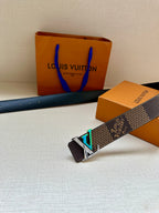 Louis Vuitton dark monogram belt with silver LV buckle and teal-green inlay