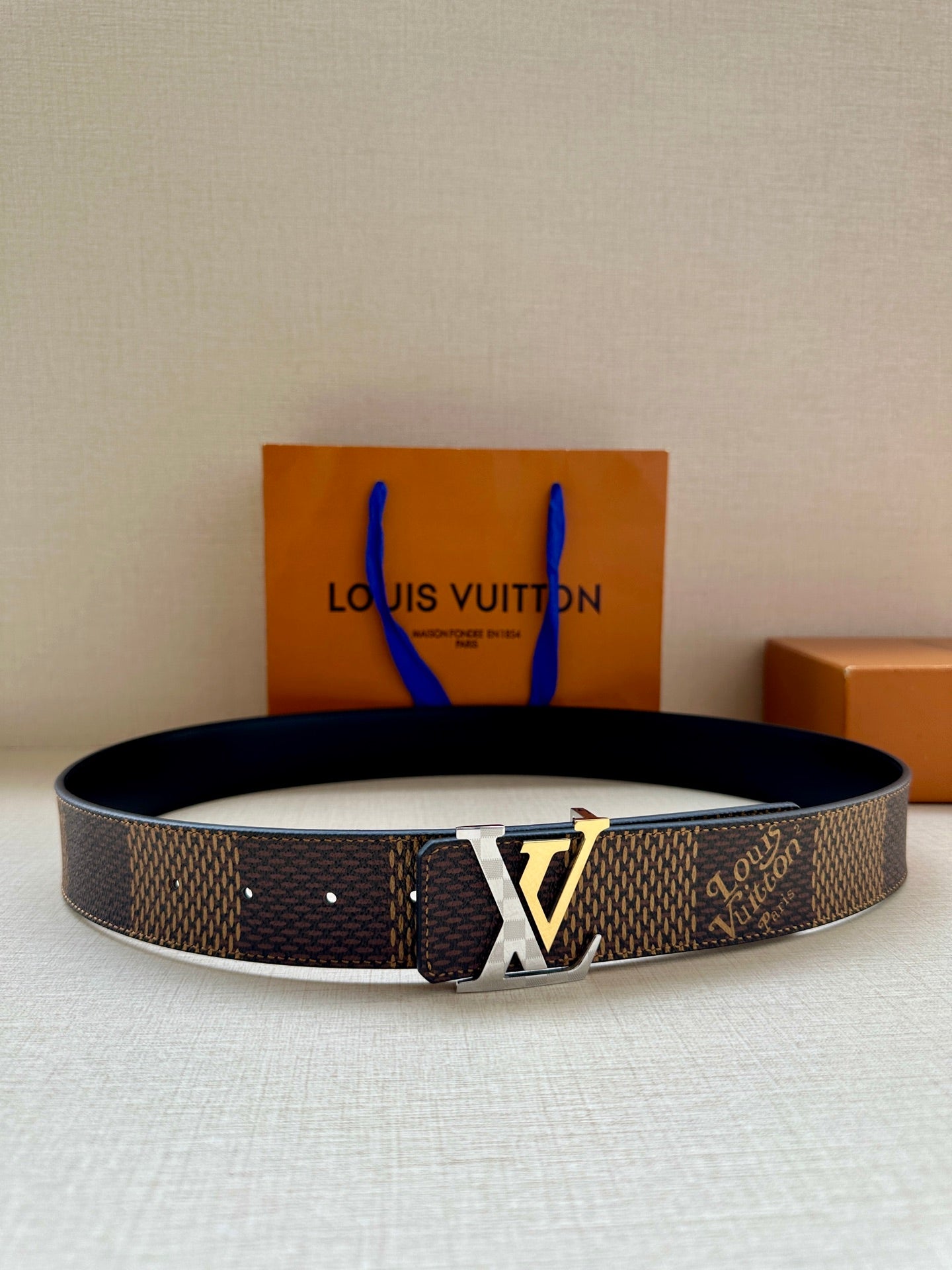 Louis Vuitton monogram canvas belt with dark strap and gold-tone LV buckle