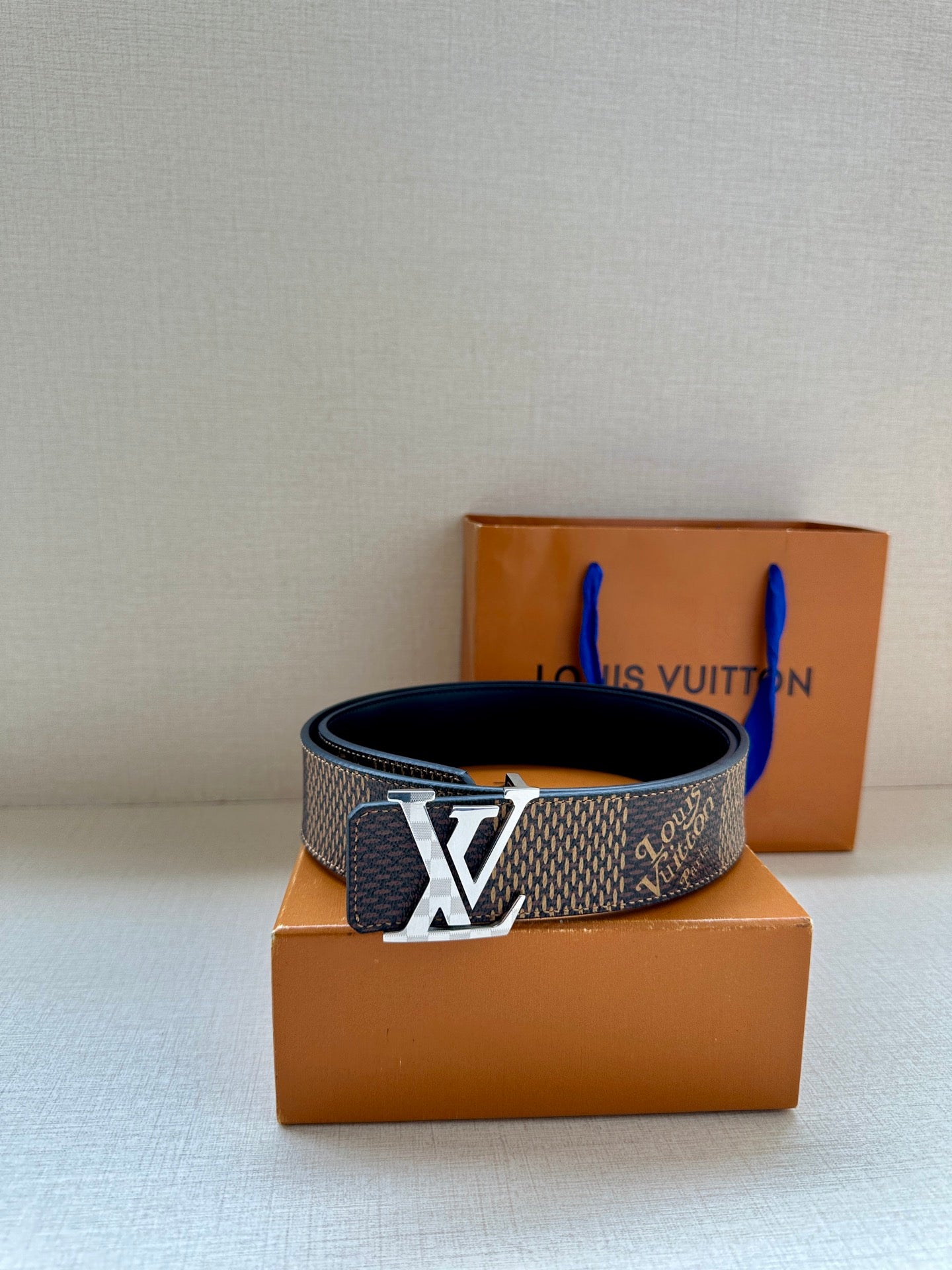 Louis Vuitton monogram belt with silver LV buckle on dark canvas strap