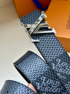 Dark blue patterned belt with large silver buckle and metallic edging