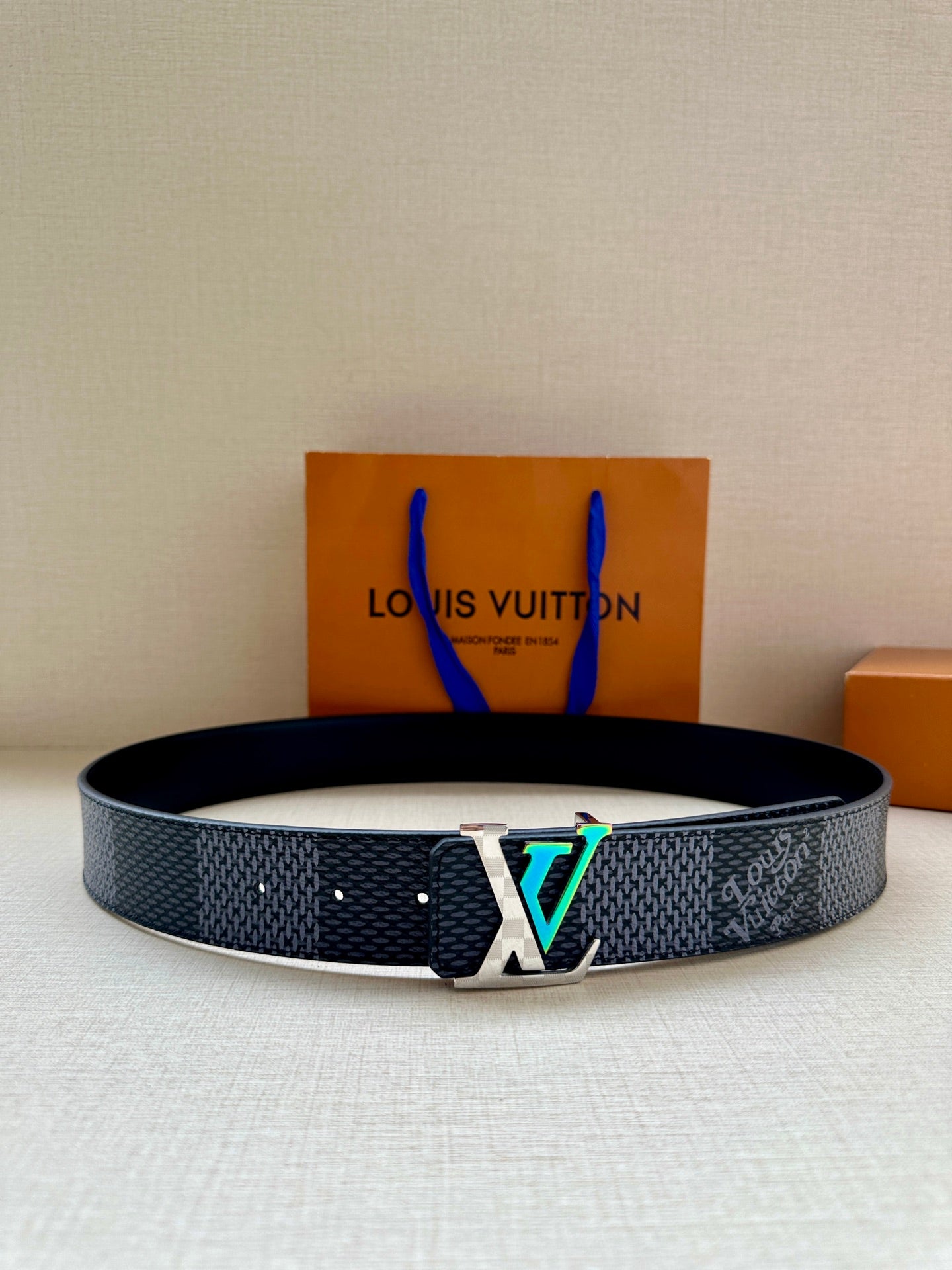 Louis Vuitton belt in dark blue textured leather with silver LV-style buckle