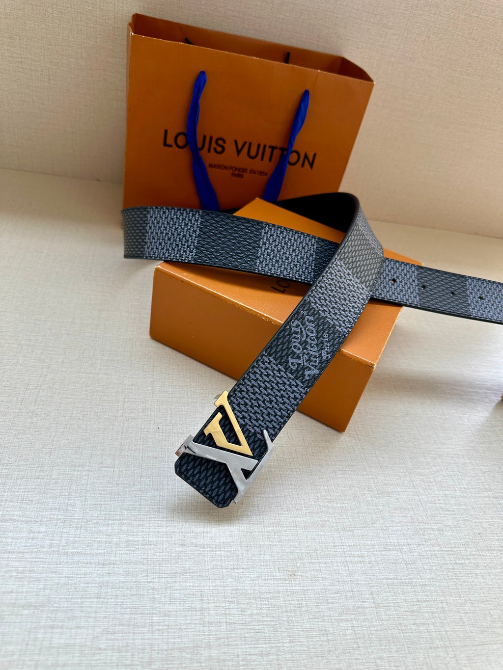 Dark blue leather belt with silver buckle and patterned finish