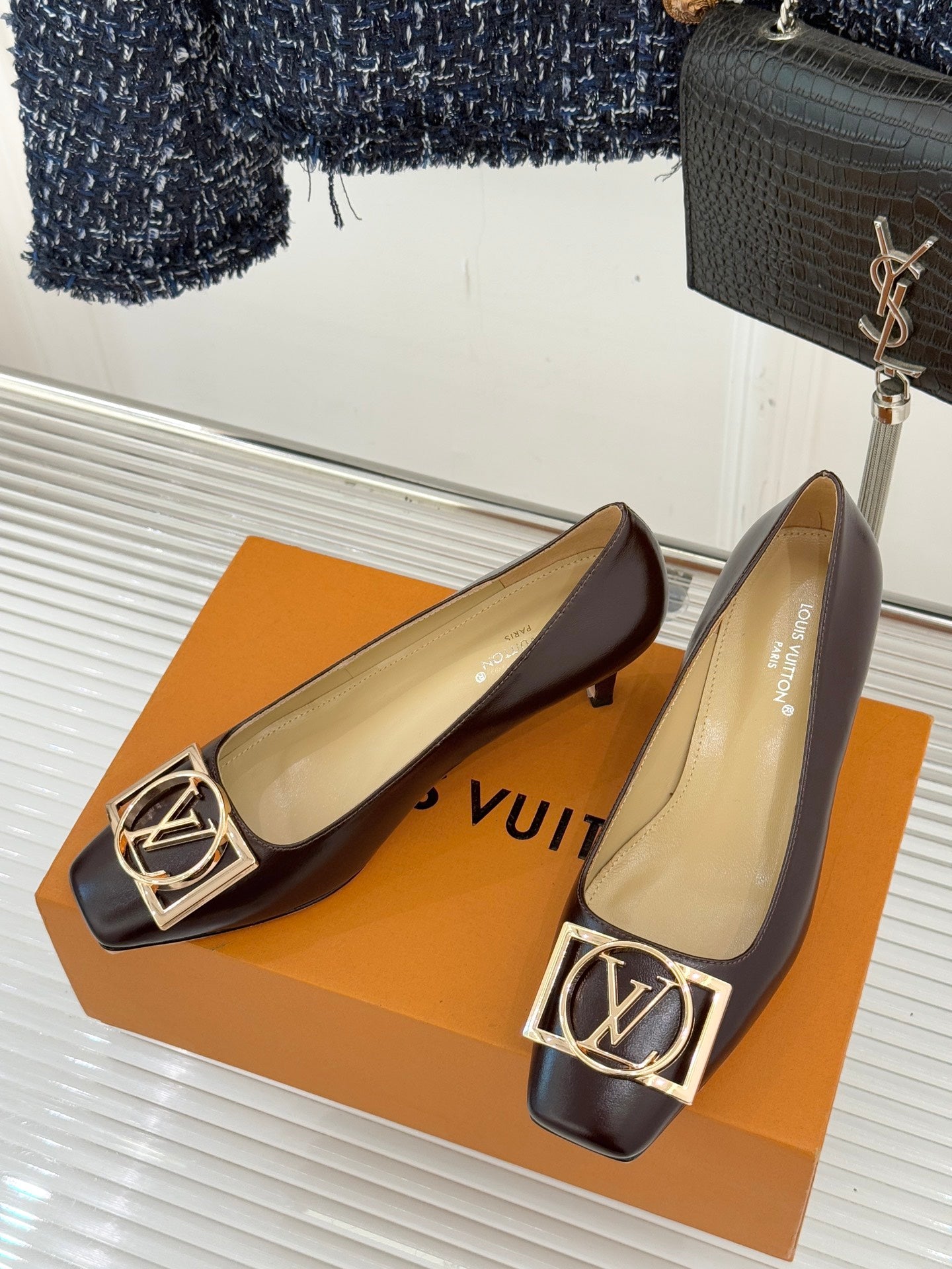 Pair of women's square-toe block-heel pumps, dark brown leather with gold LV logo detail