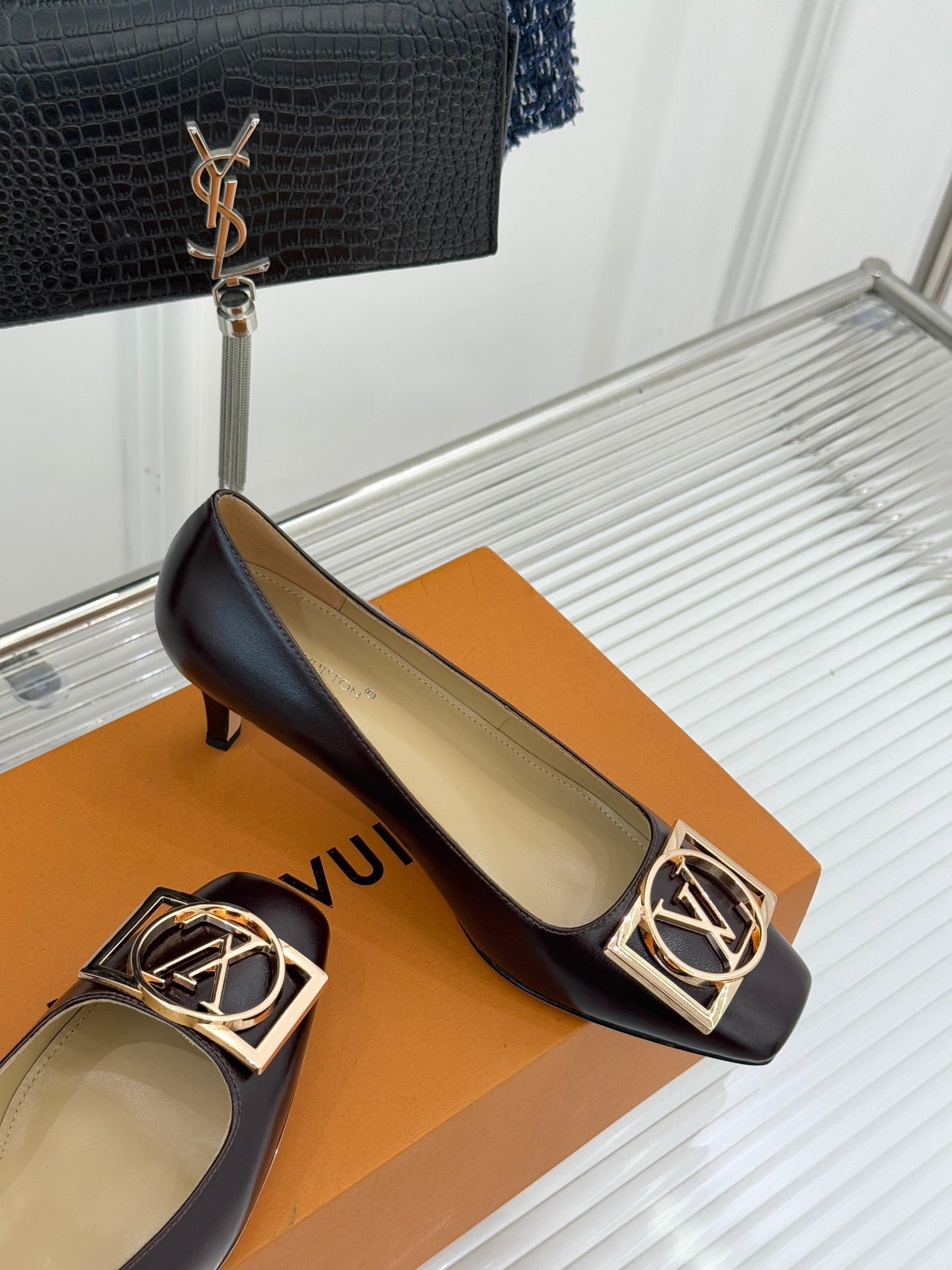 Women's dark brown square-toe block-heel pumps with gold LV logo ornament on the vamp