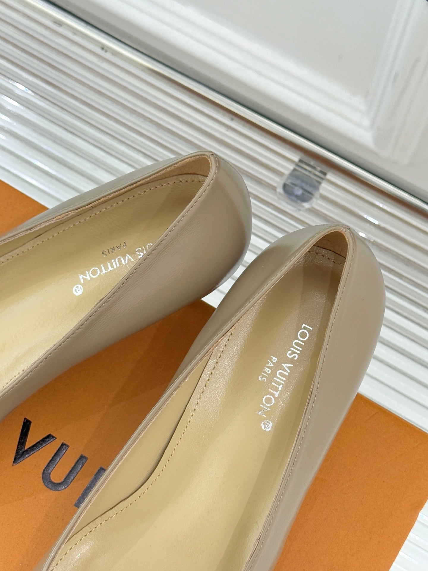 Beige Louis Vuitton ladies pointed pumps with interior branding and low heel
