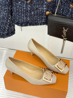 Cream Louis Vuitton pumps pair, pointed toe and gold square logo buckles