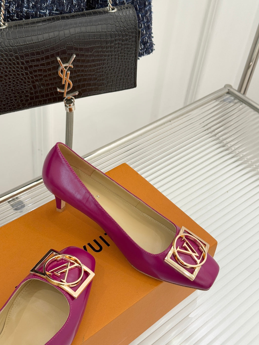 Pink Louis Vuitton ladies’ heels with gold LV logo buckle and curved low heel