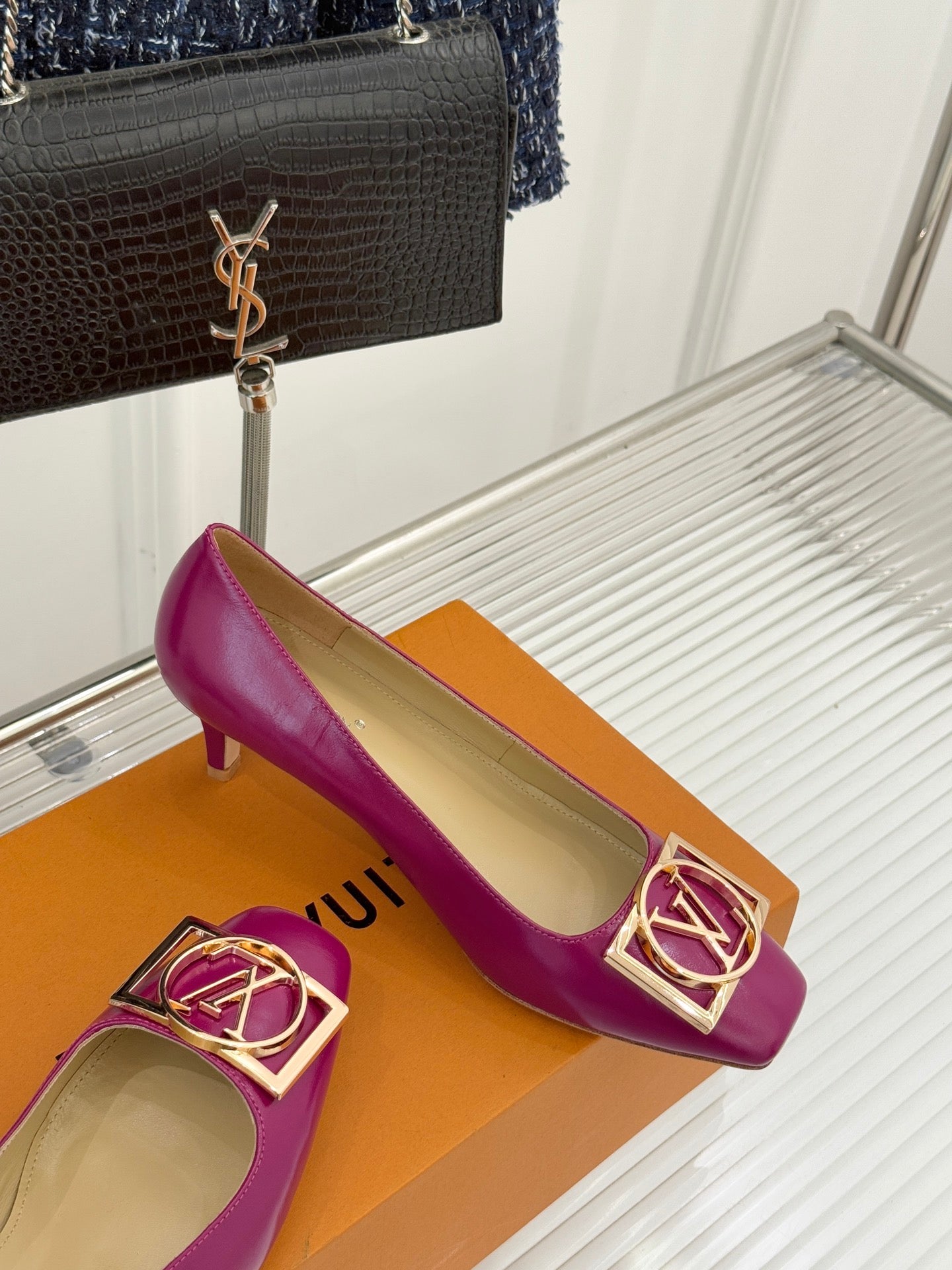 Pink Louis Vuitton ladies’ heels with gold LV logo buckle and curved low heel