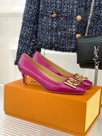 Pink Louis Vuitton ladies’ heels with gold logo buckle detail on square-toe fronts