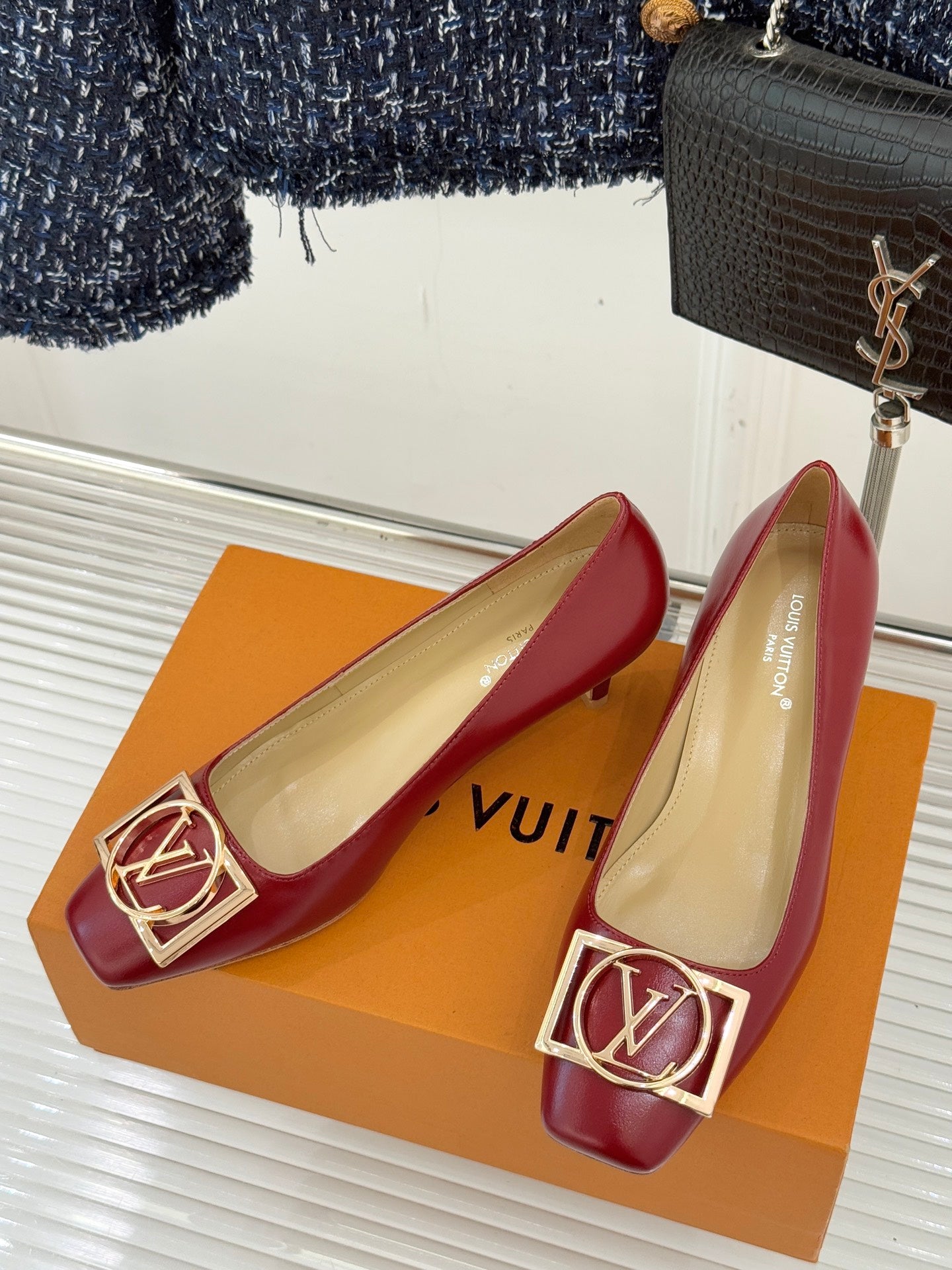 Louis Vuitton ladies red pointed-toe pumps with gold LV buckle on front, beige lining
