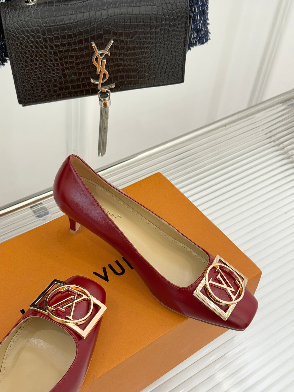 Louis Vuitton ladies red pumps with gold LV buckle detail, on orange display box