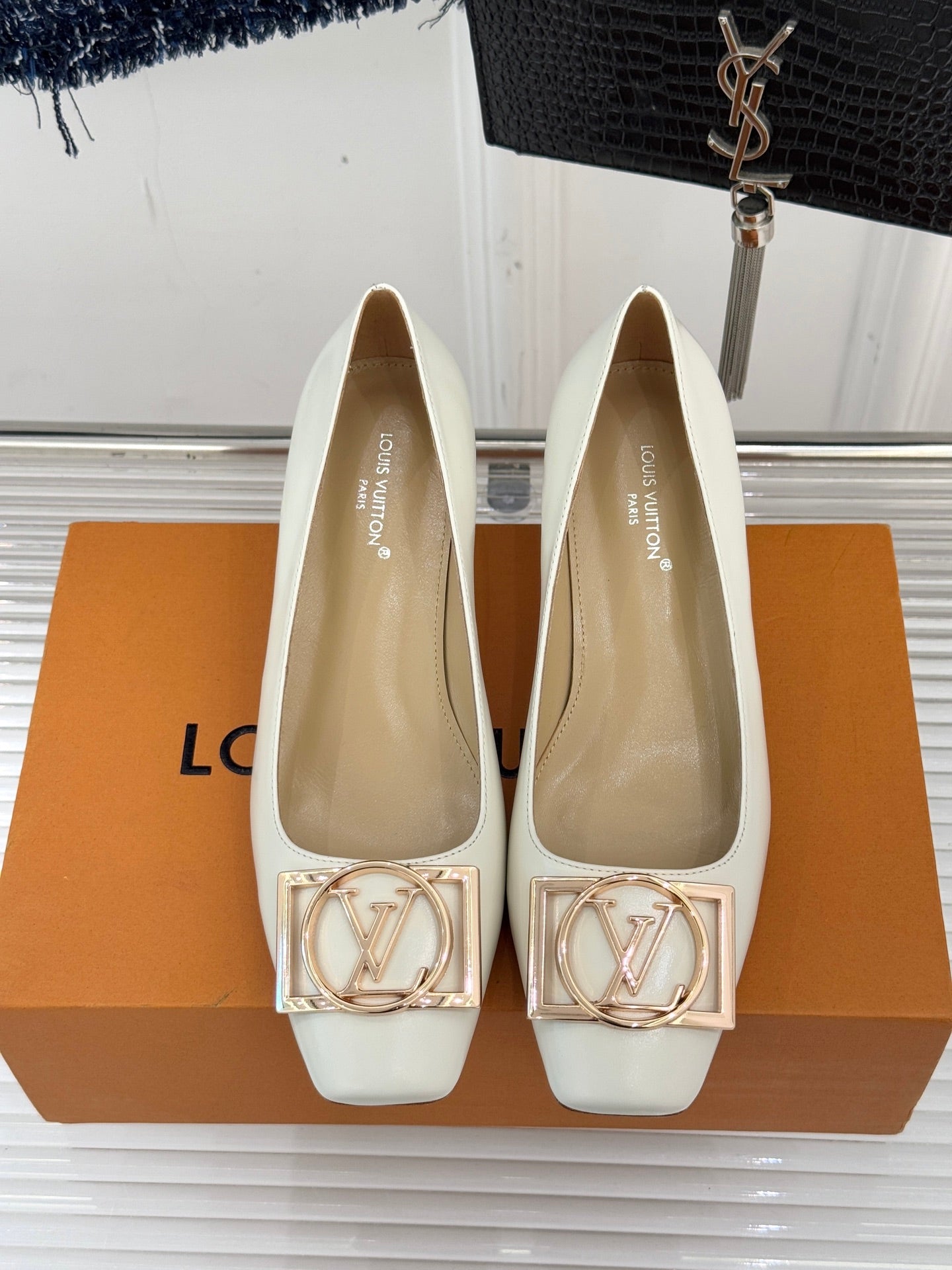 Louis Vuitton ladies’ light flats with square toe, gold-tone LV buckle, and low block heel