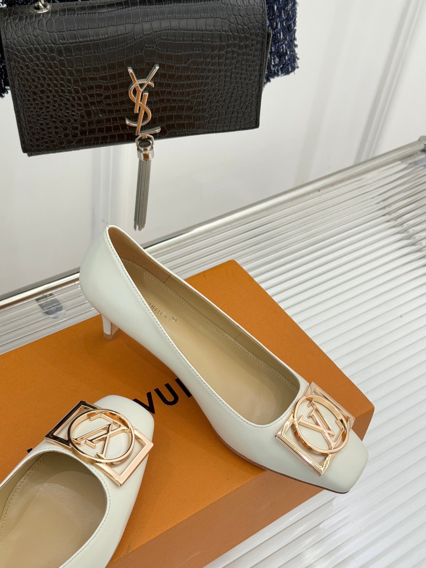 Louis Vuitton ladies’ light flats with gold-tone LV buckle ornament on front